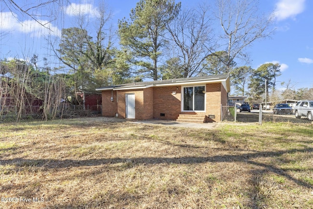 rear view of property featuring a yard