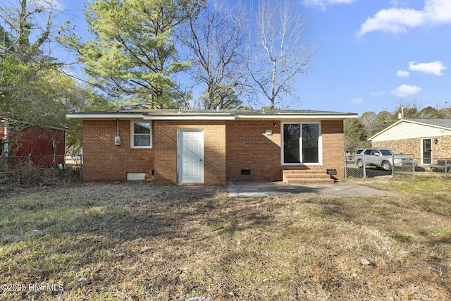 rear view of house with a patio area and a yard