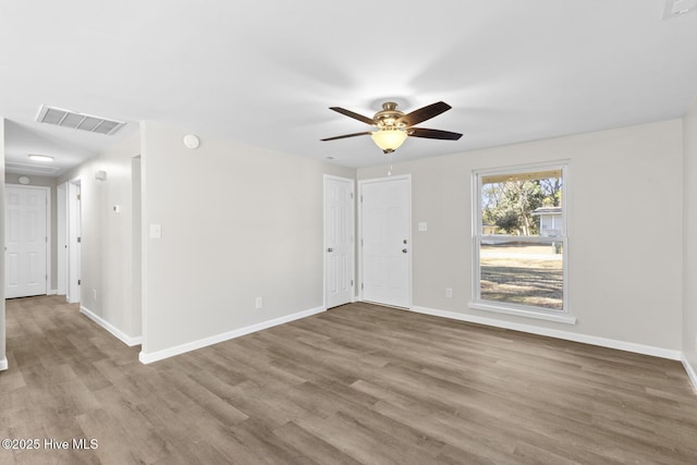 empty room featuring ceiling fan and light wood-type flooring