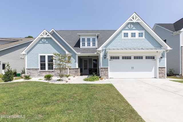 craftsman-style house with a garage and a front lawn