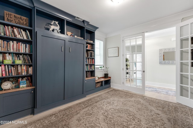 mudroom featuring light hardwood / wood-style floors, crown molding, and french doors