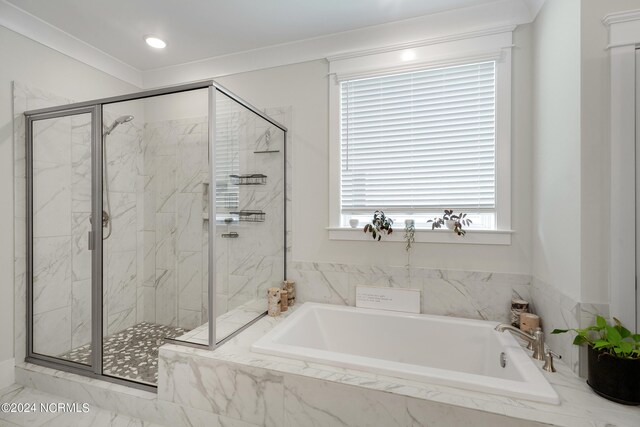 bathroom featuring crown molding and independent shower and bath