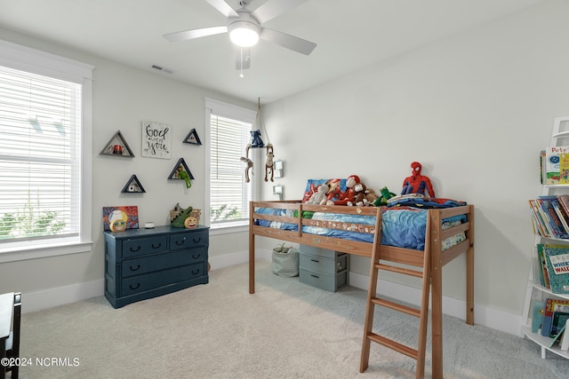 bedroom featuring ceiling fan and light carpet