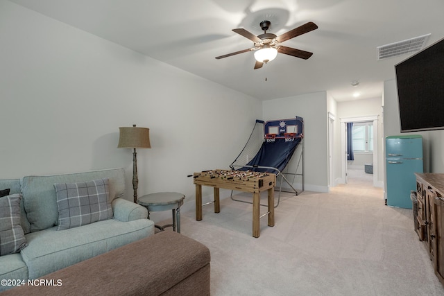 recreation room featuring light carpet and ceiling fan