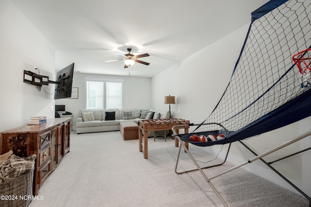 living room featuring ceiling fan and light colored carpet