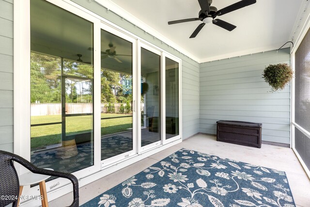 sunroom / solarium featuring ceiling fan