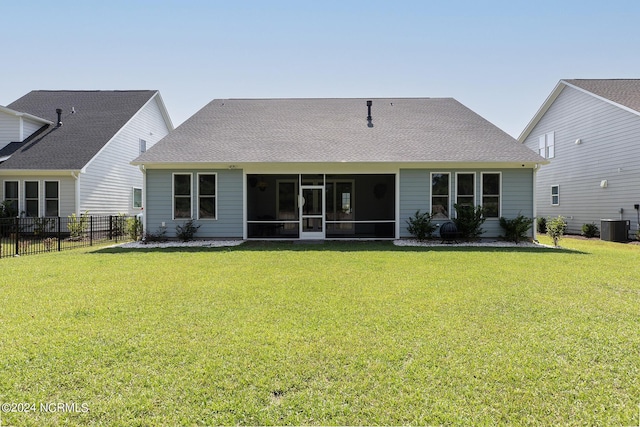 back of house with a yard, central air condition unit, and a sunroom