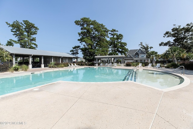 view of swimming pool with a pergola and a patio area