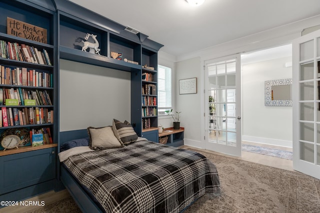 bedroom with french doors and crown molding