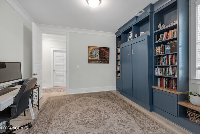 home office featuring built in features and ornamental molding