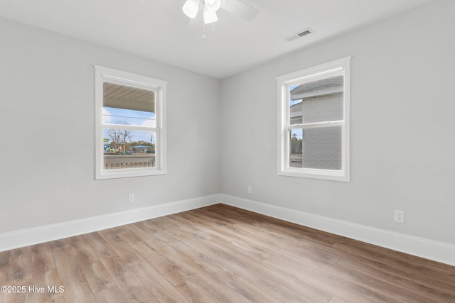 empty room with ceiling fan and light hardwood / wood-style floors