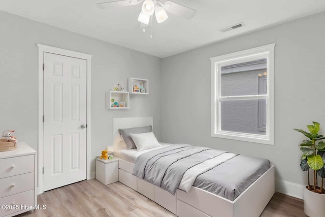 bedroom with ceiling fan and light hardwood / wood-style flooring