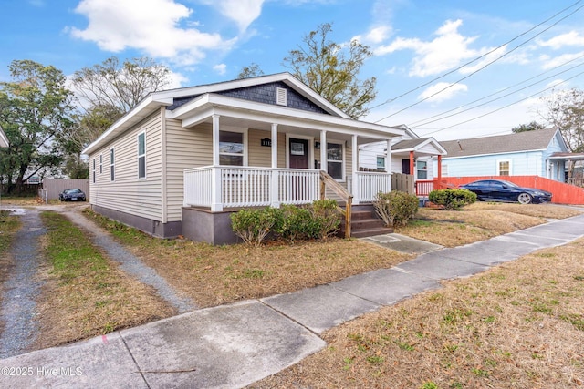 bungalow-style house with covered porch and a front yard