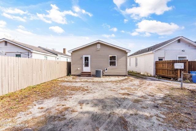 rear view of house featuring cooling unit