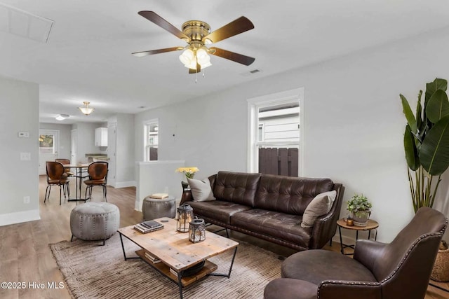 living room featuring light hardwood / wood-style floors, plenty of natural light, and ceiling fan