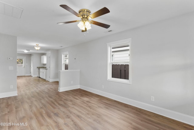 unfurnished living room with ceiling fan and light hardwood / wood-style floors