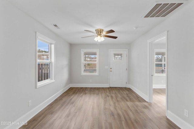 foyer with ceiling fan and light hardwood / wood-style floors