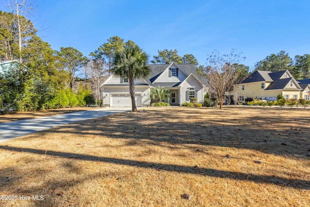 view of front of house with a garage and a front lawn