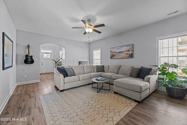 living room with hardwood / wood-style flooring and ceiling fan