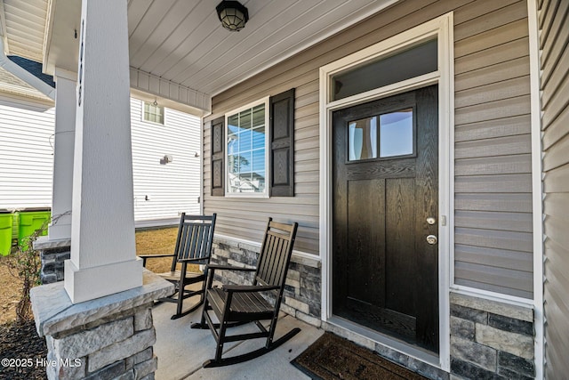 view of exterior entry featuring a porch