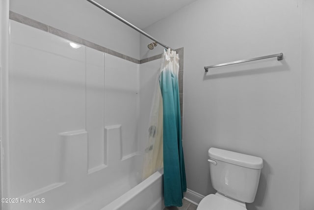 bathroom with shower / bathtub combination with curtain and toilet