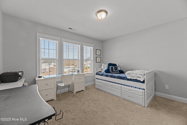 bedroom featuring light colored carpet