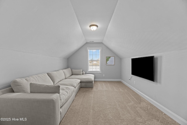 carpeted living room featuring lofted ceiling