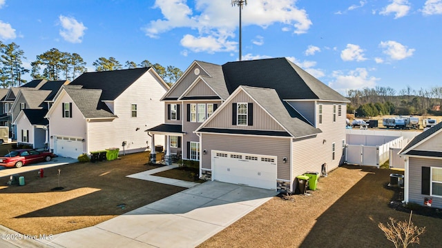 view of front of property featuring central AC unit, a garage, and a front yard