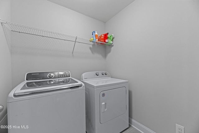 laundry area featuring tile patterned flooring and washing machine and clothes dryer