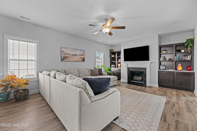 living room featuring ceiling fan and light wood-type flooring