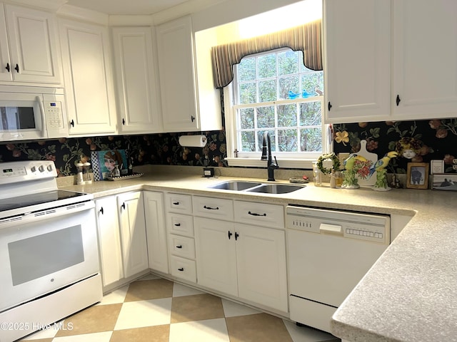 kitchen with white cabinets, white appliances, and sink