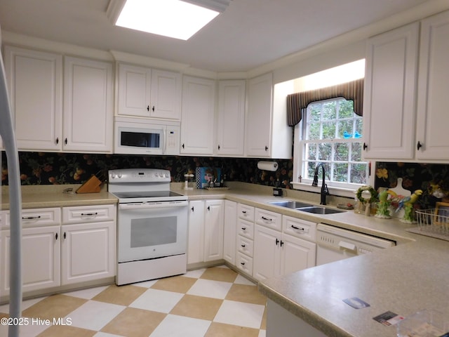 kitchen featuring decorative backsplash, sink, white cabinets, and white appliances