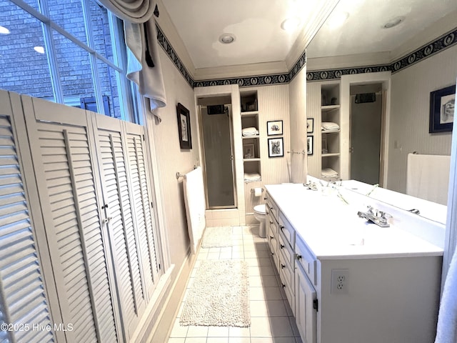 bathroom with tile patterned floors, vanity, toilet, and walk in shower