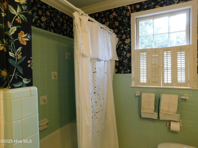 bathroom featuring shower / tub combo, toilet, tile walls, and ornamental molding