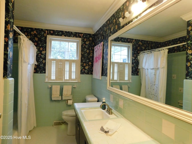 bathroom with vanity, toilet, ornamental molding, tile walls, and walk in shower