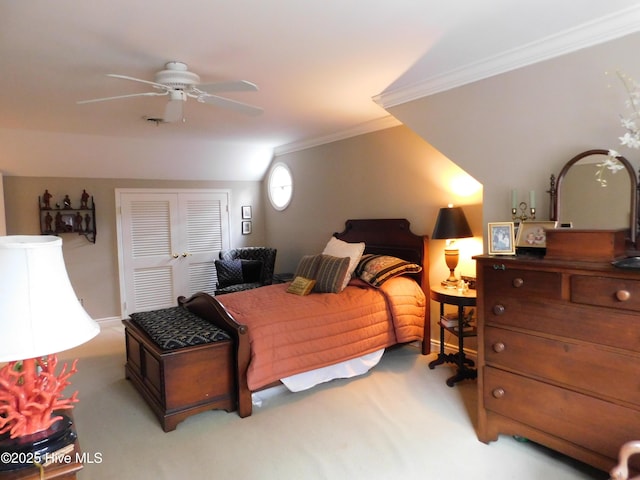 carpeted bedroom featuring a closet, ceiling fan, and ornamental molding