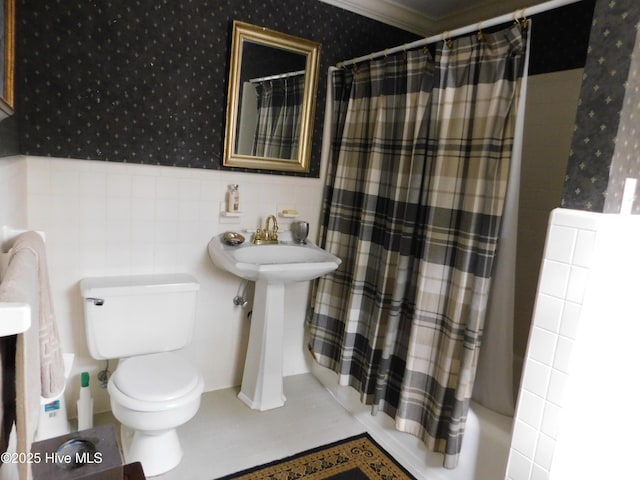 full bathroom with shower / bath combination with curtain, toilet, ornamental molding, and sink