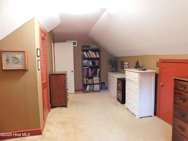 office space with light carpet and vaulted ceiling