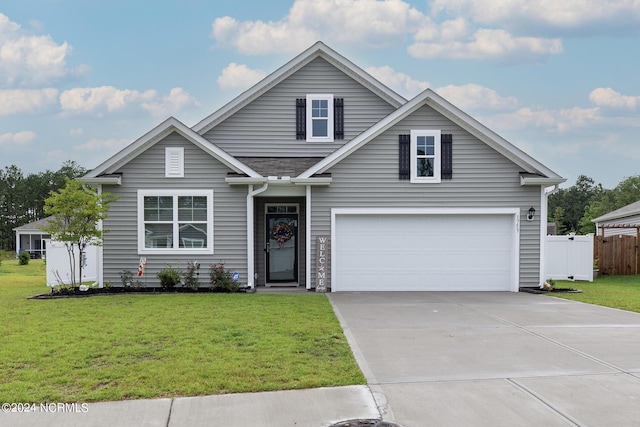 view of front facade with a garage and a front lawn