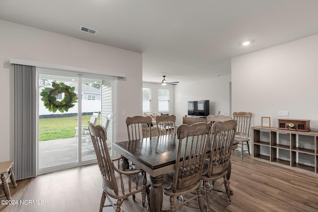 dining area with wood-type flooring and ceiling fan