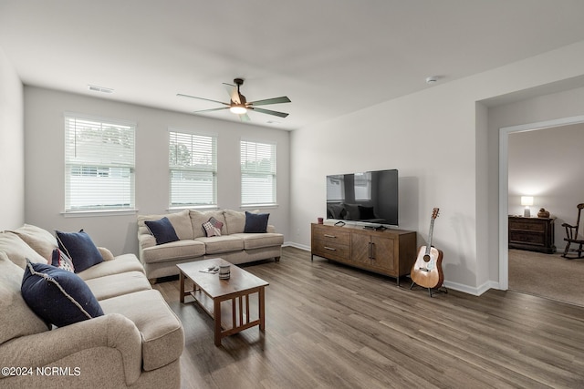 living room featuring ceiling fan, plenty of natural light, and hardwood / wood-style flooring