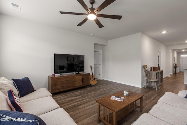 living room featuring dark hardwood / wood-style flooring and ceiling fan