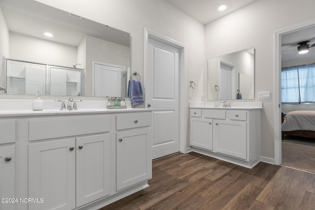 bathroom featuring vanity, wood-type flooring, and a shower with shower door