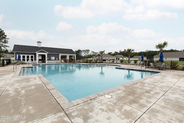 view of swimming pool featuring a patio area