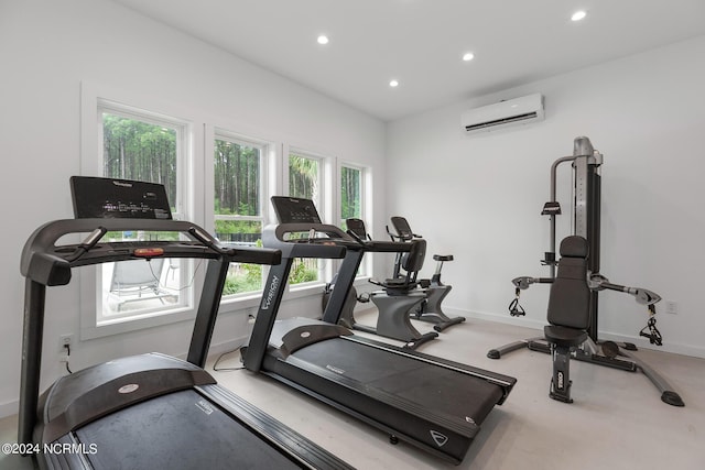 exercise area featuring plenty of natural light and a wall mounted AC