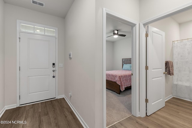 entrance foyer with ceiling fan and wood-type flooring