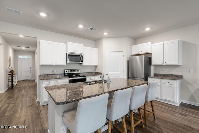 kitchen featuring a kitchen island with sink, white cabinetry, sink, and appliances with stainless steel finishes