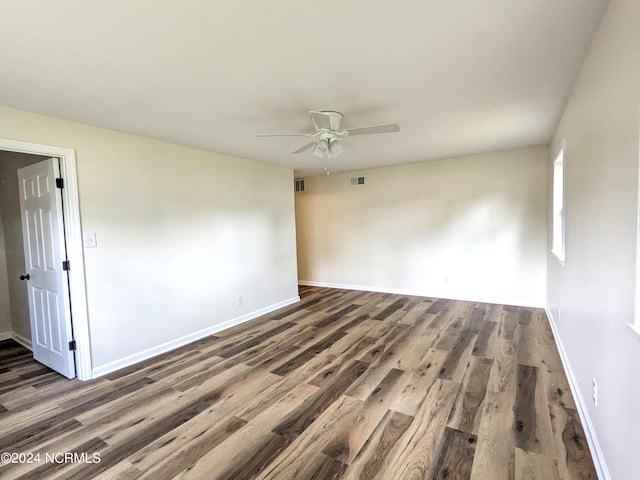 empty room featuring ceiling fan and dark hardwood / wood-style floors