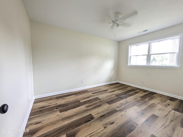 empty room featuring ceiling fan and dark wood-type flooring