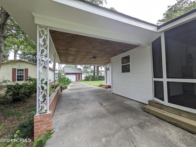 view of patio with an outdoor structure and a carport